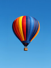 Naklejka premium Colorful hot air balloon flying in clear blue sky. Minimalist and vibrant image representing travel, adventure, freedom, and summer mood.