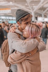 Fototapeta premium A man and woman hugging each other in an airport