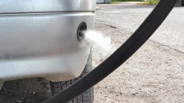 A gas leak occurred due to faulty gas equipment. Car at a gas station is filled with LPG propane or methane CNG gas. 
