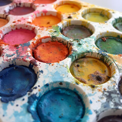 Closeup of a well-used watercolor palette, watercolor, used, palette, art supplies, closeup, colorful.