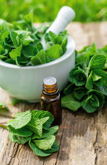 Peppermint extract essential oil and supplements. Selective focus.