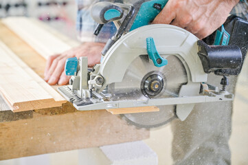 A skilled craftsman operates a circular saw on a wooden plank, showcasing precision and...