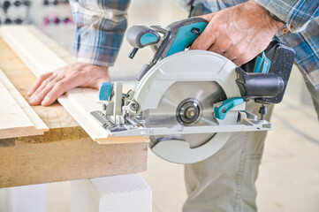 A skilled craftsman operates a circular saw on a wooden plank, showcasing precision and craftsmanship in a well-lit workshop environment, highlighting woodworking techniques