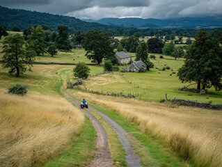 Farm scene with a rider on a quad bike among fields and barns