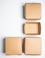 Obraz premium Three neatly arranged boxes of varying sizes and colors—one red, one blue, and one yellow—set against a clean white background, creating a vibrant contrast.