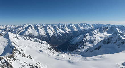 Panoramic View Of Snow Covered Mountain Range Under A Clear Blue Sky
