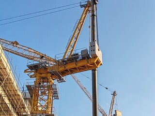 Yellow Color Fixed Crane Erected Beside Under Construction Residential Building.
Highrise Portable...
