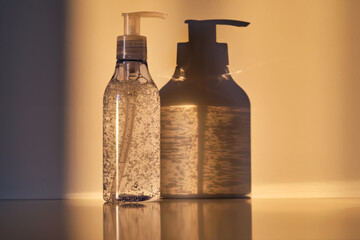 A tube of cosmetic gel or shower gel in the rays of the setting sun.