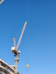 Yellow Color Fixed Crane Erected Beside Under Construction Residential Building.
Highrise Portable Remote Mobile Tower Crane Lifting Heavy building Material from ground to top level construction site.