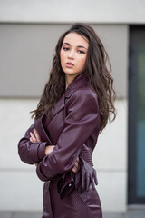 Modern feminine outfit with high-quality burgundy leather skirt and structured jacket styled for...