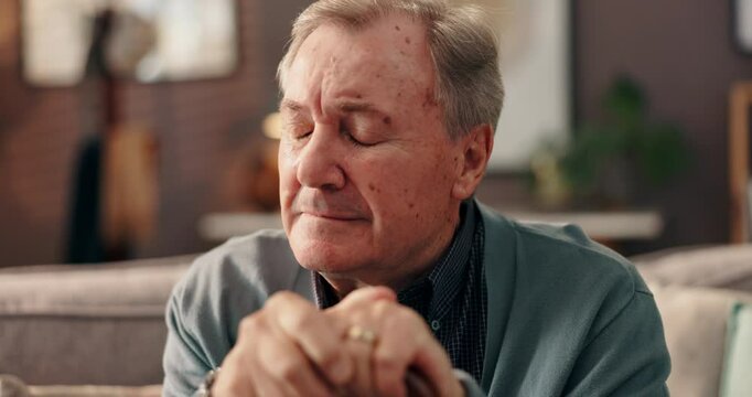 Home, thinking and senior man with walking stick, sad and grief with retirement, loss and anxiety. Apartment, pensioner and elderly person on sofa, cane and mental health with nostalgia and memory