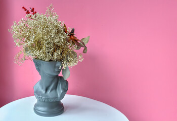 Modern Still Life: Dried Gypsophila in Grey Sculptural Head Vase on Pink. Artistic Decor: Dried...