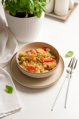Quinoa vegetable salad on white wooden table. Vegetarian and diet food
