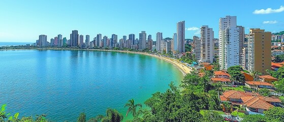 Fototapeta premium Coastal city skyline with beach and turquoise water. High-rise buildings line the shore, surrounded by lush greenery