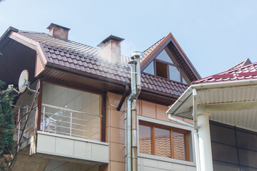 A house with a chimney and a window on the second floor