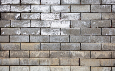 A brick wall with a grey color