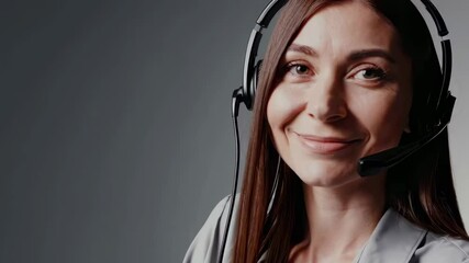 Friendly customer service representative communicating with headset in professional setting