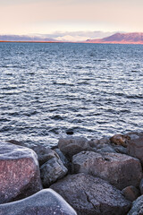 Reykjavik, Iceland- 21 November 2021: Embankment of Reykjavik town, capital of Iceland, with view to the Atlantic Ocean from and Sæbraut street at dawn. During the Covid 19 pandemic, on a cold day.