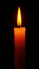 Fototapeta premium Isolated flickering candle flame, bright orange and yellow against a pure black background , dark, hope