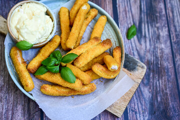 Crispy  deep fried home made    chicken strips Breaded  with  almond flour chicken  breast fillets  with chilly peppers and fresh   basil on wooden rustic background. Ketogenic diet food