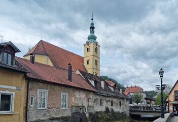 An overcast day in Samobor showcases the steeple of St. Anastasia Church rising above charming old...