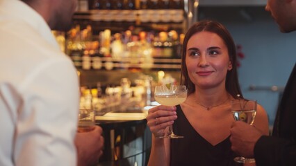 Focusing beautiful woman lively talking with friends while enjoy drinking Margarita cocktail at luxurious counter bar nightclub creating vibrant engaging atmosphere on Friday night meeting. Vinosity.