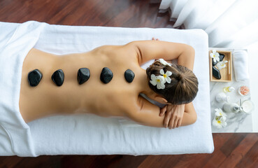 Panorama top view hot stone massage at spa salon in luxury resort with day light serenity ambient,...