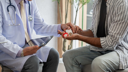 Obraz premium A caring doctor and nurse assist a couple during a medical consultation about treatments and medications.