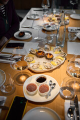 Champagne tasting, Wine glasses are on the table, stylish table setting, sparkling wine bubbles, oysters and sea urchins, special sauce