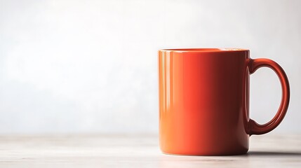 Obraz premium of a single orange mug on a white surface in a 