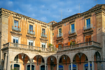 Historic buildings in morning light in Piazza Giuseppe Mazzini in Catania, Sicily, Italy, with porticos and columns