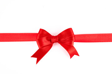Red ribbon and bow on white background