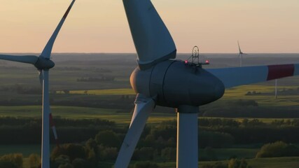 Wind farm at sunrise, wind generators aerial view, windmills generating electricity, drone shot, golden hour, green renewable energy, wind turbine