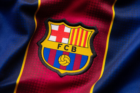 Kyiv, Ukraine, May 6, 2025. Close-up of FC Barcelona football jersey showing club emblem on fabric with maroon and blue colors.