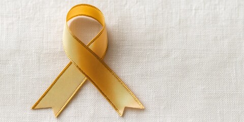 albinism awareness, detailed golden albinism awareness ribbon close-up set against a white fabric backdrop to convey advocacy and support