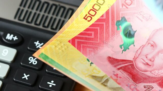 Costa Rica money and calculator. Man counting Costa Rican colones. banknotes. Financial economic concept. Business background. closeup