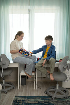 Siblings Sharing Creative Moments with Educational Toy