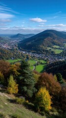 Picturesque Valley View with Hills Forests and Townscape Beneath a Blue Sky with Clouds in Autumn
