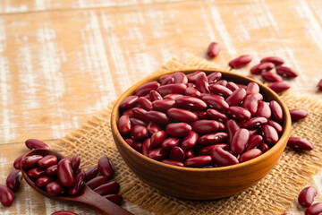 Close up Uncooked Kidney bean or Red beans in wooden teak bowl.