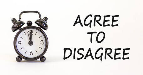 Agree to disagree symbol. Concept words Agree to disagree on beautiful white paper. Alarm clock....