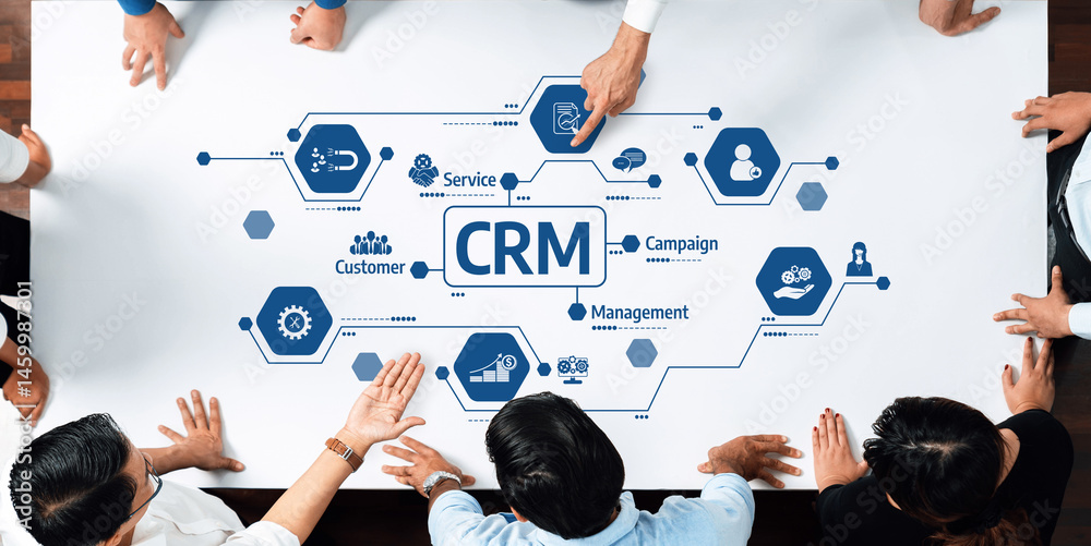 Poster Aerial view of diverse professionals working together on a CRM project. Focus on teamwork, strategy, and customer service improvement in a modern office environment. Amity