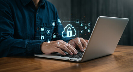 Man typing on laptop with cloud security icons hovering over the keyboard on a wooden surface business, data