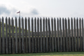 Fototapeta premium A British flag in the distance over a wooden barrier. 
