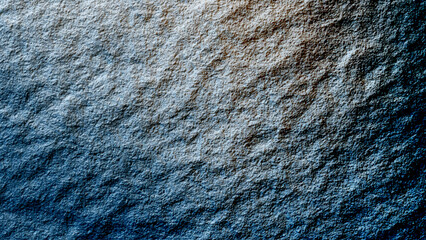 Close-up of a rough and weathered dark rock surface, texture of marble stone cut close up

