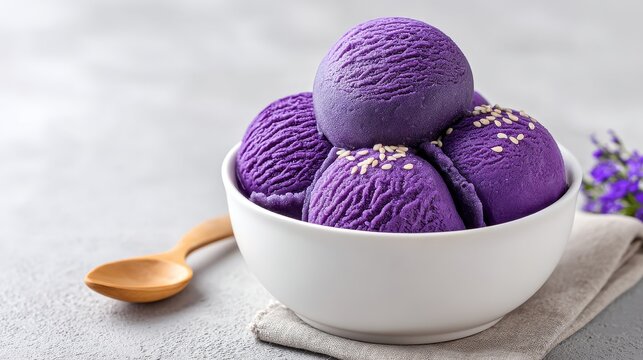 Delicious Ube Ice Cream Scoops - Three scoops of vibrant purple ube ice cream topped with sesame seeds in a white bowl