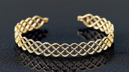 Fototapeta premium Delicate gold bracelet with intricate woven design.