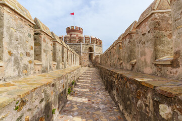 Historic Anamur caslte, Fort Wall Walkway With Stone Structure and Turkish flag on a tower..