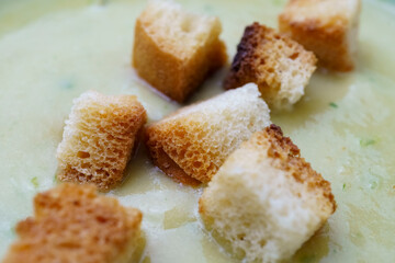 Close up of toasted croutons to be added to cream soup. Healthy eating, home cooking