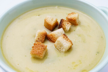 Close up of toasted croutons to be added to cream soup. Healthy eating, home cooking