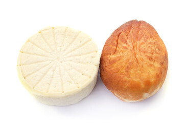 Two round heads of homemade cheese.
